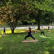 teens doing yoga with masks on on lawn