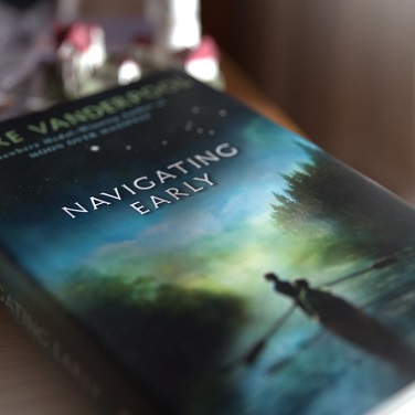 Cover of book Navigating Early by Clare Vanderpool depicting two teens in a rowboat on the water