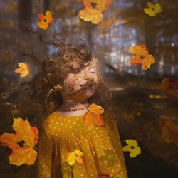 autumn leaves falling on little girl