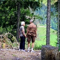 senior couple walking in woods