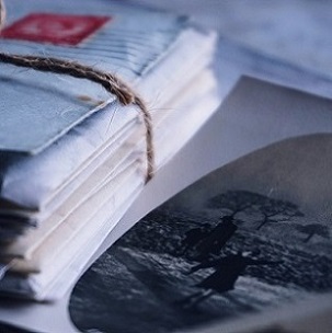 old time photograph beside stack of old letters