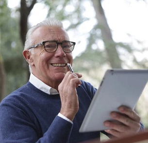 Male Senior with pad of paper and pen