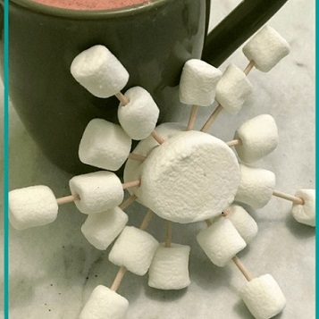 marshmallows and toothlicks arranged in snowflake pattern