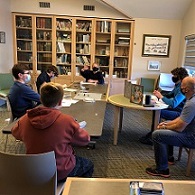 Teens in masks playing dungeons and dragons