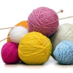 balls of yarn with knitting needles