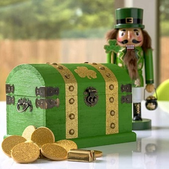 wooden box painted green with shamrock stickers and gold coins alongside