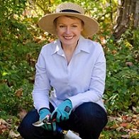 woman kneeling with gardening shears