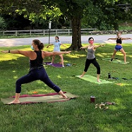 teens doing yoga on lawn