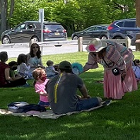 families gathered on lawn during storytime