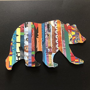 outline of a bear decorated with strips of magazine paper