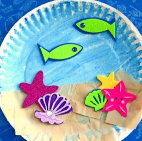 ocean scene with fish and shells drawn on paper plate