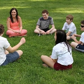 teens sitting in circle on lawn