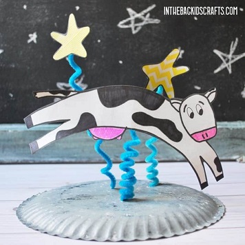 picture of cow attached to spiraled pipe cleaners to appear to be "Jumping" over moon