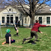 teens playing volleyball on the lawn