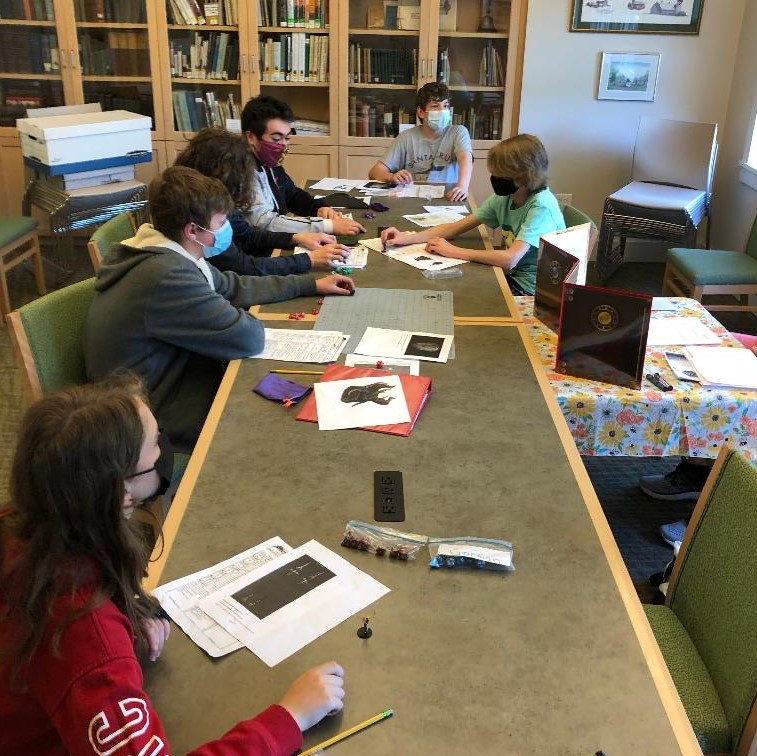 masked teens playing Dungeons & Dragons