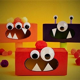 tissue boxes painted and decorated to look like monsters with googly eyes and jagged teeth