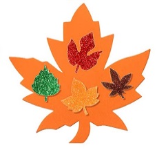 Large orange leaf made of constrctino paper, decroated with smaller coloful glitter leaves