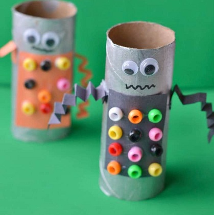 "robot" crafted from toilet paper roll, googly eyes, colorful beads and construction paper