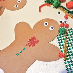 foam gingerbread man bring decorated with googly eyes, sparkly bowtie and shiny buttons