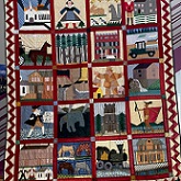 quilt with blocks including train, horse, church