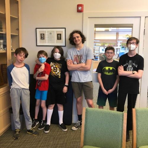 6 boys posing in library room