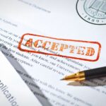 word "Accepted" stamped over an admissions office letter