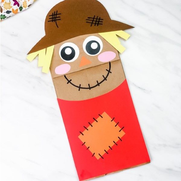 Paper bag decorated with markers and cut out construction paper to look like a scarecrow puppet