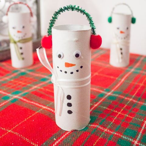 empty toilet tube decorates to look like a snowman, with pipe cleaner and pompom ear muffs