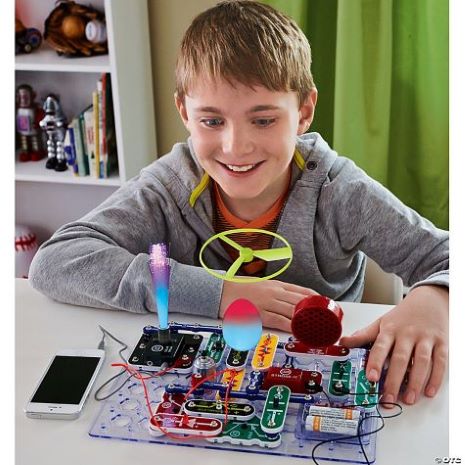 boy playing with electronic snap circuits hooked up to his phone