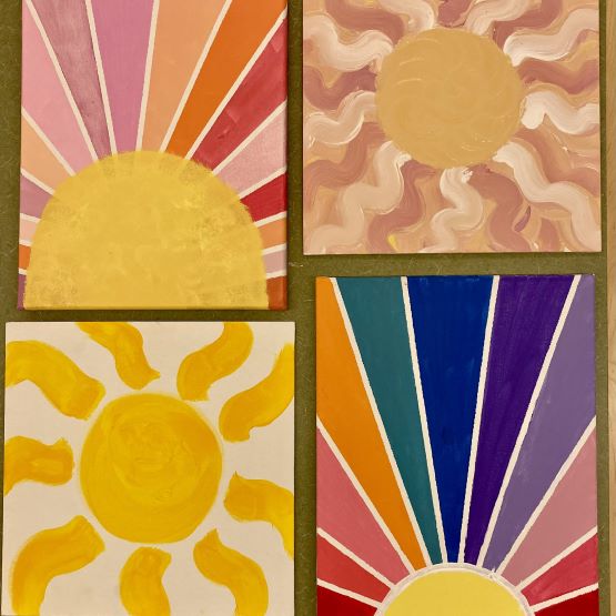 four canvasses with different paintings of the sun