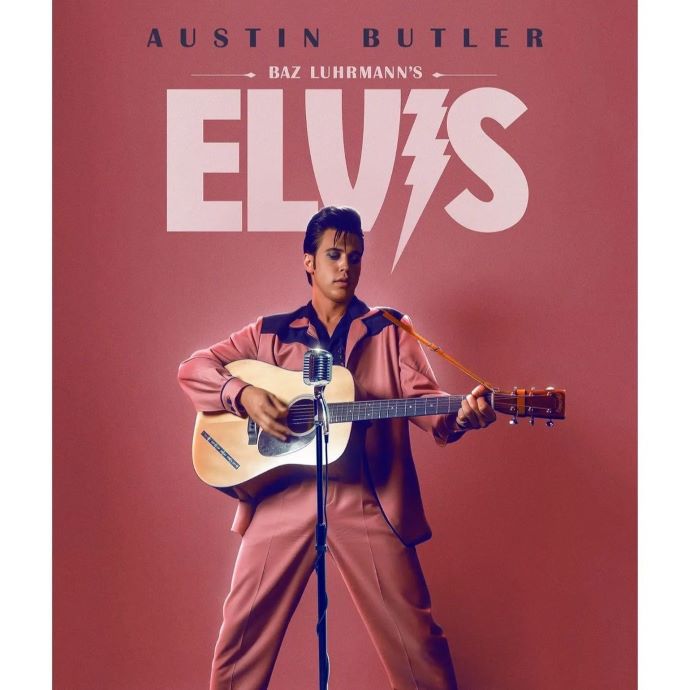 movie poster for film Elvis with actor dressed like Elvis Presley and playing a guitar in front of a microphone