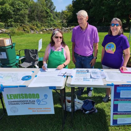 Table with sign Lewisboro Comprehensive Steering Committee, tended by two wome and a man