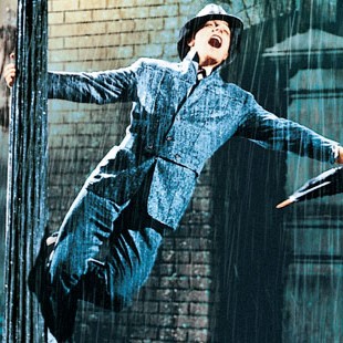 actor Gene Kelly in rain gear dancing in the rain