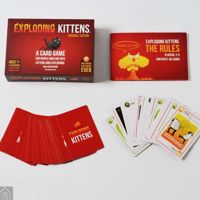 Exploding Kittens game box with sample cards and rule book