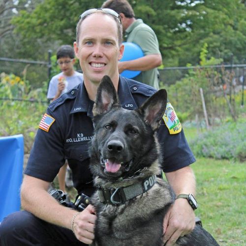 police officer posing with canine officer