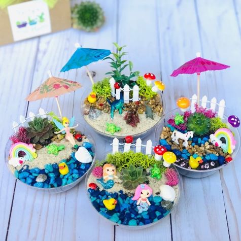 mini potted gardens with succulents, sand and beach figures