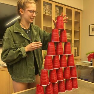 teen girl stacking red solo cups