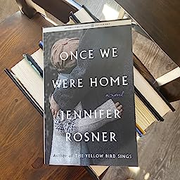book jacket with words "Once we Were Home" over photo of child hugging an adult