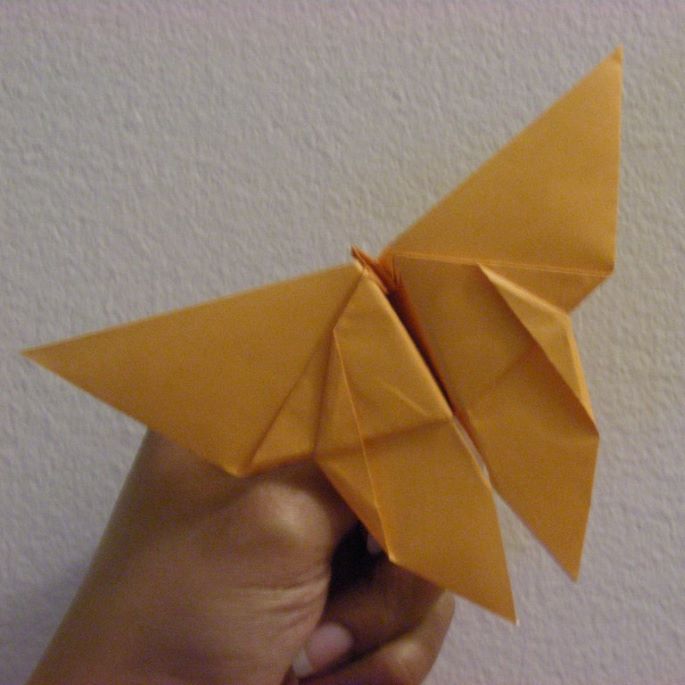 yellow paper folded into an origami butterfly