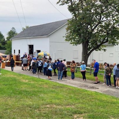 people waiting in line to enter barn