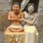 A painted family portrait limestone statue of the dwarf person Seneb with his wife Senities