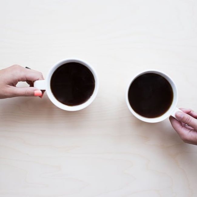 Overhead view of two cups of coffee on a table