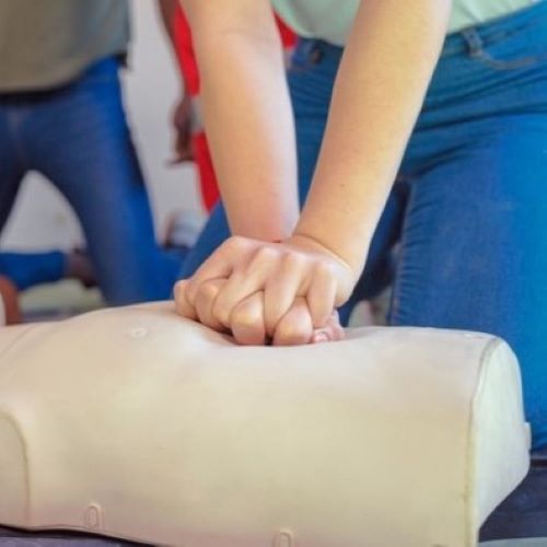 set of hands doing CPR on a dummy