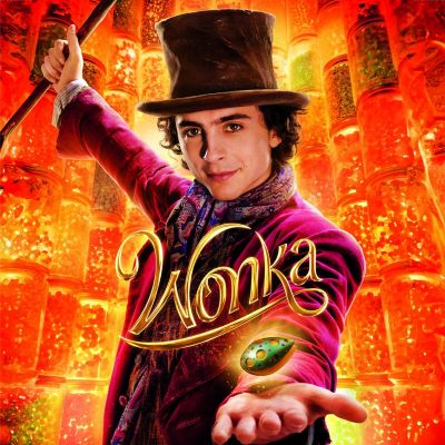 Young Man in top hat and purple suit with Wonka written in script across his body.