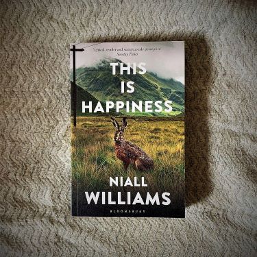 Book Jacket showing rabbit in a field below title This is Happiness