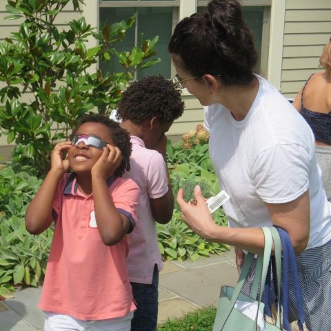 Child using special eclipse glasses to view the eclipse in 2017