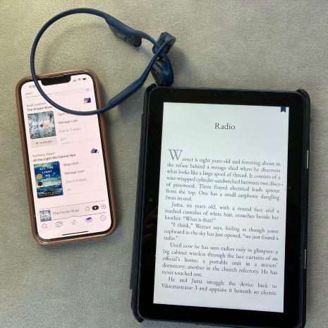 iphone and headphones next to eBook reader