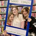 Three teen girls holding sign that reads Good Times at Lewisboro Library