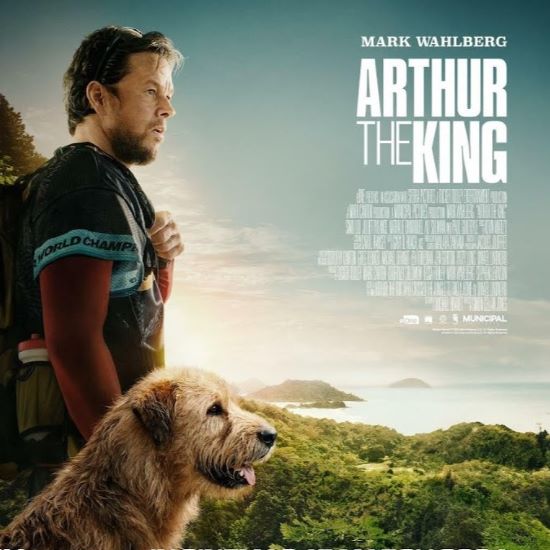 movie poster featuring a man and dog on a jungle cliff looking out at ocean