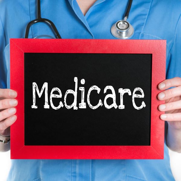 health professional holding chalkboard that reads Medicare